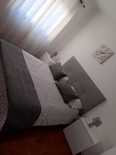 a bedroom with a large bed and a window at O Fernando in Caminha