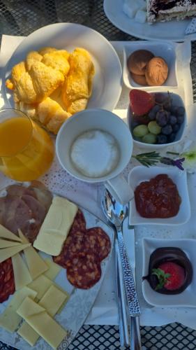 a table topped with plates of cheese and other foods at Villa Conte in Podstrana