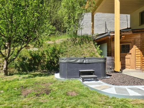 a backyard with a fire pit next to a house at Ferienwohnung Colleen in Fügenberg