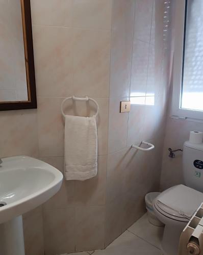 a bathroom with a shower and a toilet and a sink at Hostal Restaurante Yagual in Sahagún