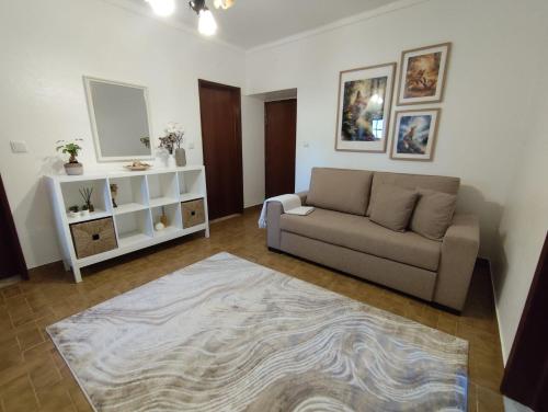 a living room with a couch and a rug at Toca da Raposa in Estremoz