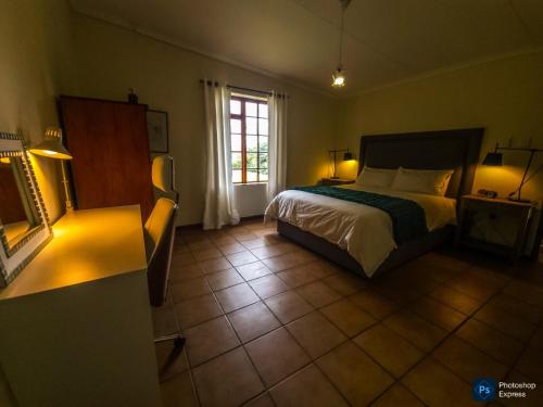 a hotel room with a bed and a window at The GingerPig Inn in Die Ark