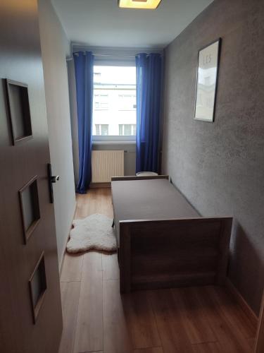 a small room with two beds and a window at Aparto 1 in Złotów