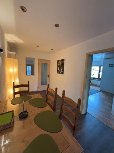 a dining room with a table and chairs at Haus Waldesruh, 3 Ferienwohnungen in Hemfurth-Edersee