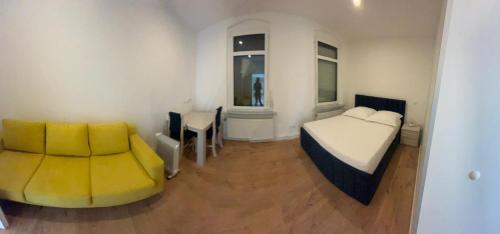 a bedroom with a bed and a table and a chair at Ferienwohnung in Glauchau