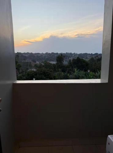 a window in a bathroom with a view at Backpackersnest in Entebbe