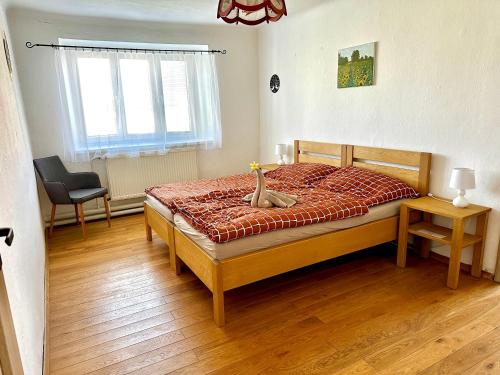a bedroom with a bed with a cat sitting on it at Apartmán Dolní Němčice in Dačice