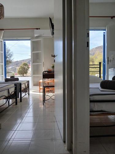 a room with a view of a bedroom with a bed at Andromeda in Ios Chora