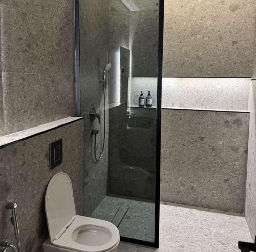 a bathroom with a shower with a toilet and a shower at منتجع دار DAR Resort in Hail