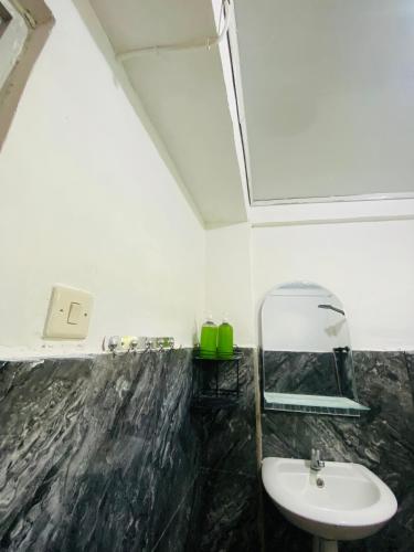 a bathroom with a sink and a mirror at Tiba Meka Homestay in Komodo Labuan Bajo Airport