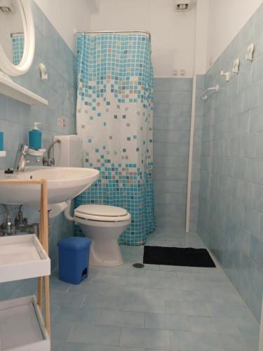 a bathroom with a toilet and a sink and a shower at Andromeda in Ios Chora