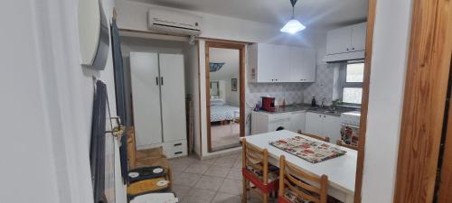 a kitchen with a table and a dining room at Abbronzatissima Capo d'Orlando in Capo dʼOrlando