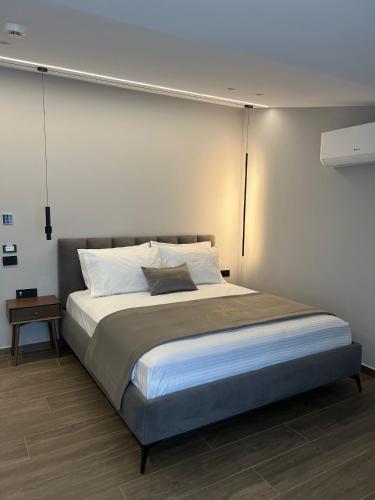a bedroom with a large bed with white pillows at AMAD Aparthotel in Sarandë