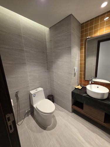 a bathroom with a toilet and a sink at Mandala Chambay Mũi Né - TAQ in Mui Ne