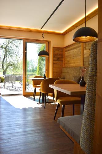 a living room with a table and chairs at Landhaus Riedl in Bad Füssing