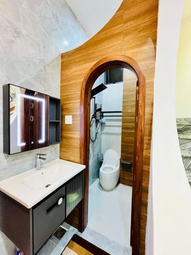 a bathroom with a sink and a toilet at Ruby Home Quy Nhon in Quy Nhon