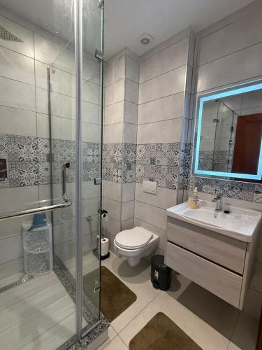 a bathroom with a shower and a toilet and a sink at Sublime appartement F4 a draria in Alger