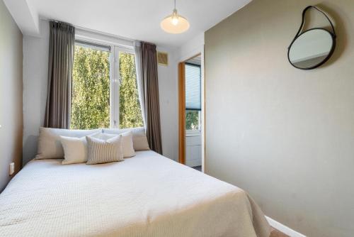 a bedroom with a bed with a large window at Bed zonder Breakfast in Amsterdam