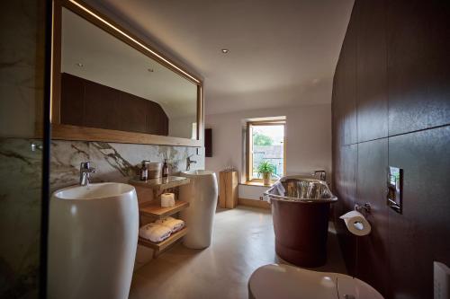 a bathroom with two sinks and a mirror at The Angel at Hetton in Hetton