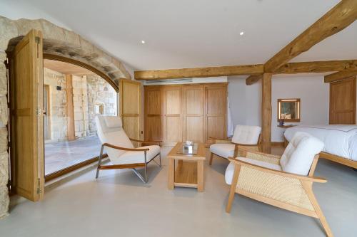 a bedroom with a bed and chairs and a table at The Angel at Hetton in Hetton
