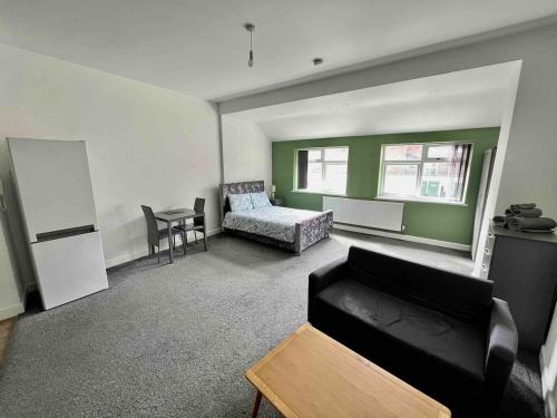a living room with a couch and a table at The Limes! Flat 3 Private Studio Apartment in Quinton