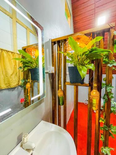 a bathroom with two potted plants and a sink at Nature Rest Ashored in Sigiriya