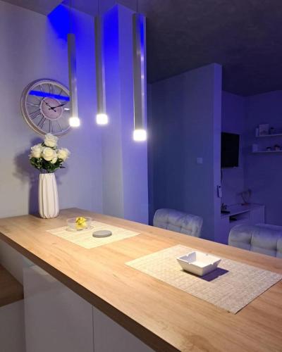 a kitchen with a counter with a vase of flowers at Apartman JakšićS&M in Šid