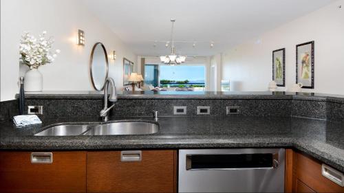 a kitchen with a sink and a mirror at 122 Mariners Club in Key Largo