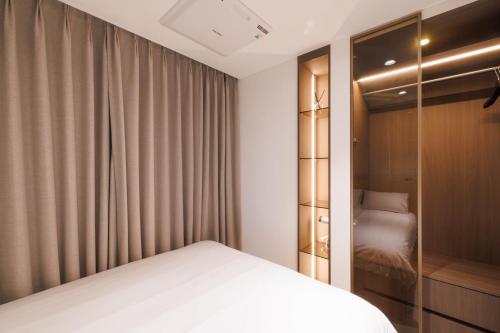 a bedroom with a bed and a closet at Seoul Modern Cozy Stay in Seoul