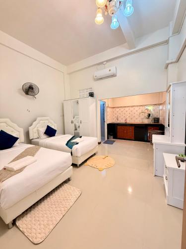 a hotel room with two beds and a bathroom at Pause Homestay 2 Hat Yai in Hat Yai