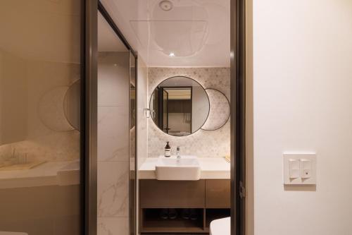 a bathroom with a sink and a mirror at Seoul Modern Cozy Stay in Seoul