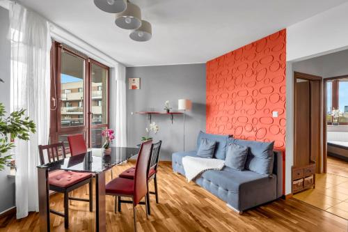 a living room with a blue couch and a table at Spacious 3Rooms Apt with Balcony Parking in Warsaw