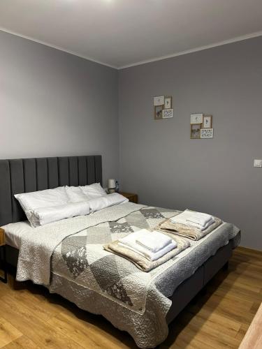 a bedroom with a bed with towels on it at Hello Tu Modlin in Zakroczym