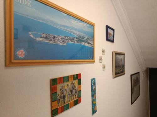a group of pictures hanging on a wall at Yükser Pansiyon in Side