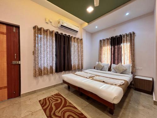 a bedroom with two beds and a window at Crescent Holiday Homes in Panchgani