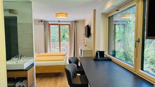 a room with a bathroom with a sink and a mirror at Hupfmühle Pension in St. Wolfgang