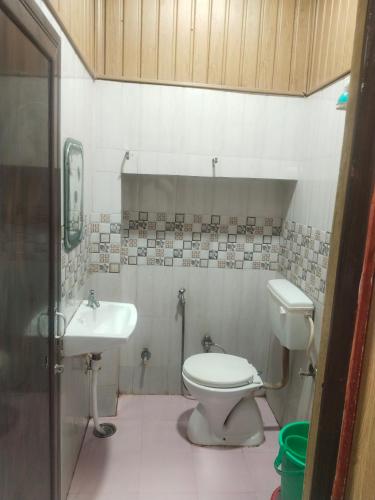a bathroom with a toilet and a sink at hotel sooryoday j in Varanasi