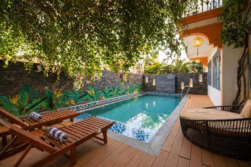 a swimming pool in a backyard with a wooden deck at Nova Vista Villa Hoi An in An Bàn (2)
