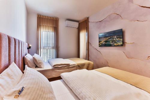 a hotel room with two beds and a cracked wall at Numa by Kraft in Podgorica