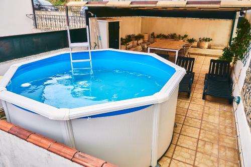 a large hot tub sitting on top of a patio at Douro Panorama Valley in Pinhão