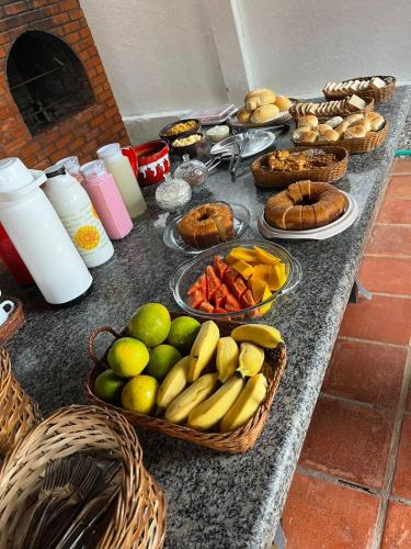 a table with baskets of fruits and vegetables on it at Pousada Brisa do Oceano - Cumbuco in Cumbuco