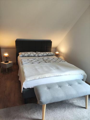 a bedroom with a large bed and two lamps at Tiny Bauernhof Plau in Plau am See