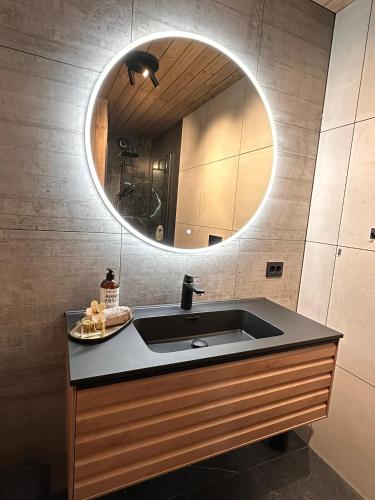 a bathroom with a sink and a mirror at Stryn Nature Lodge in Stryn