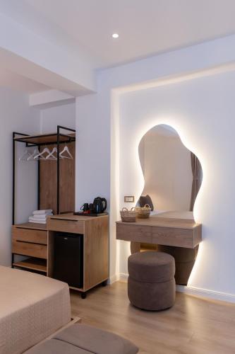 a bedroom with a bed and a table with a chair at Villa White in Ksamil