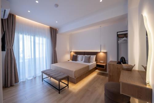 a bedroom with a bed and a chair in a room at Villa White in Ksamil