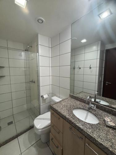 a bathroom with a toilet and a sink and a shower at Beach Class Fortaleza by AM in Fortaleza