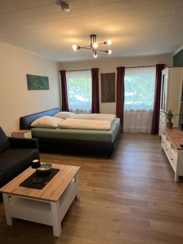 a bedroom with a bed and a coffee table at Über dem Dörpken in Wuppertal