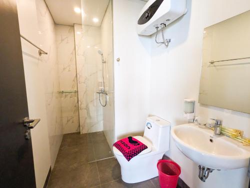 a bathroom with a toilet and a sink at Lovina 21-AA at One Residence in Batam Center