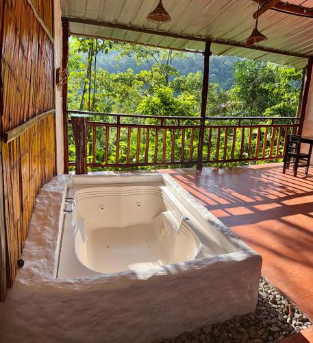 a large bath tub on a porch of a house at Posada Turistica Dantayaco fin del mundo in Mocoa