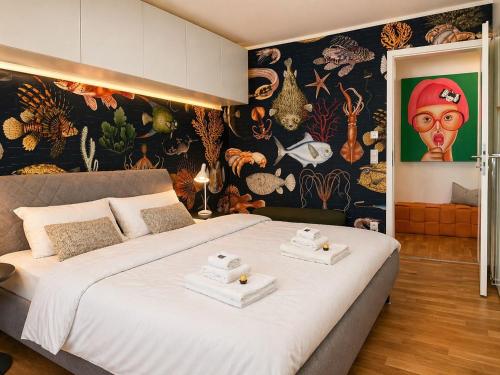 a bedroom with a large bed with towels on it at Bodensee Loft in Daisendorf